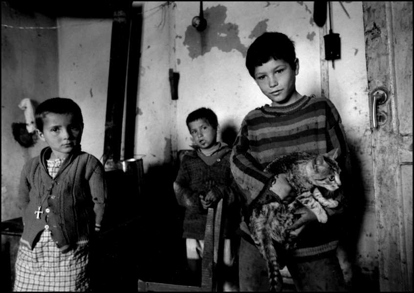 Kids in Village home with cat, Elbasan, Albania 1992 : Albania 1992 : BILL FOLEY 