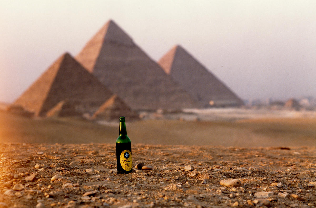 Stella beer bottle sits in front of the Pyramids on the Giza plateau 1993.

 : Egypt 1978-2018 : BILL FOLEY 