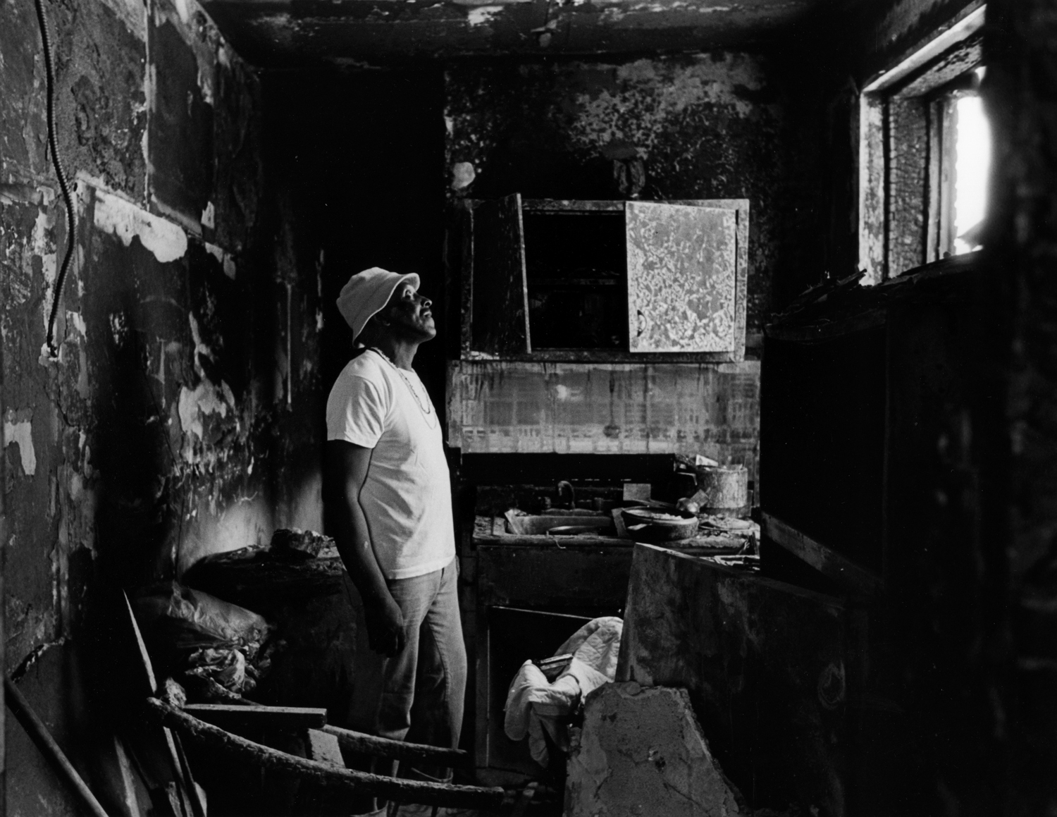 Bobby, the Super inspects apartment that was firebombed during tenant dispute. : Carmel Hill Harlem NYC 1995-2000 : BILL FOLEY 