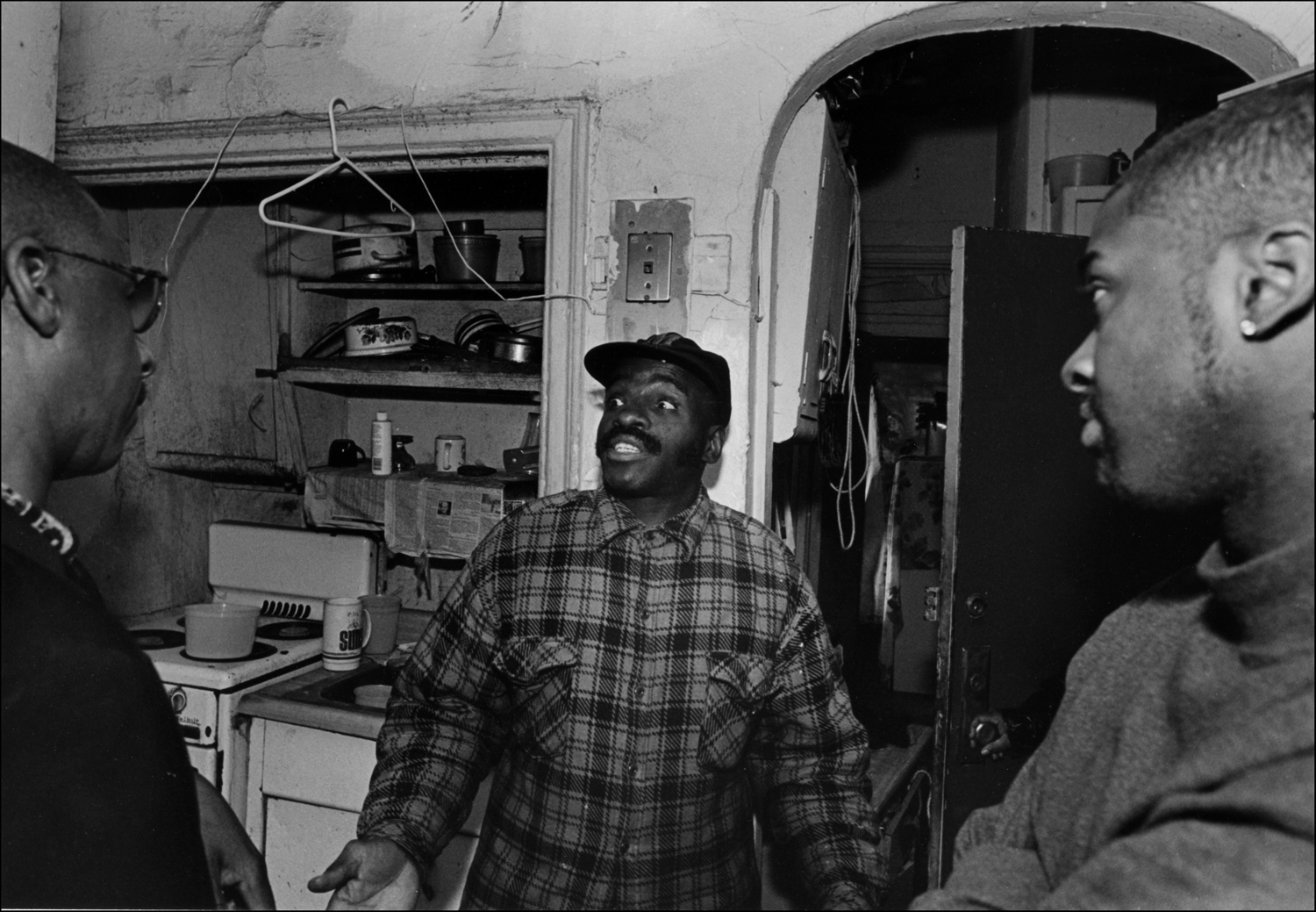James explains to social worker and Carmel hill executive how bad his apartment is. : Carmel Hill Harlem NYC 1995-2000 : BILL FOLEY 
