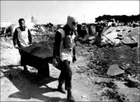 Another Victim of the Sabra and Chatilla Massacre carried on stretcher. 1982 - © 2023 Bill Foley. All Rights Reserved.