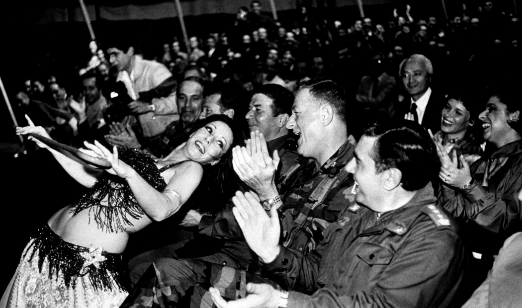 US Marine Commander, General James Mead claps as Lebanese belly dancer performs for the commanders of the multi national "peacekeeping force" in Beirut, along with civilians1982.

 : USMC in Beirut 1982-1983 : BILL FOLEY 