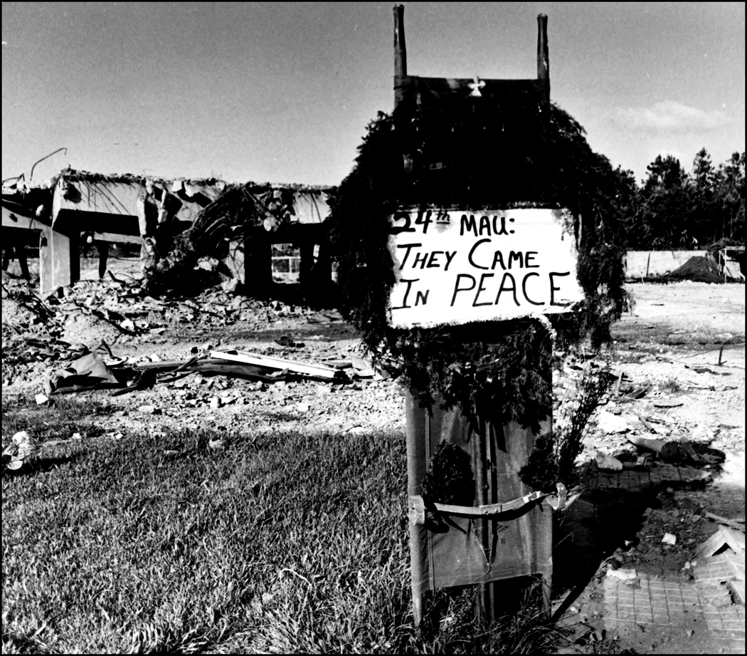 Beirut Dec. 1983, "24th MAU They came in Peace" note and Christmas wreath decorate a stretcher at the site of the destroyed US Marine HQ at Beirut airport.  : USMC in Beirut 1982-1983 : BILL FOLEY 