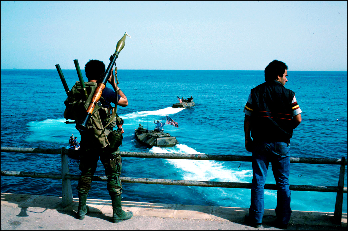 Druse militamen watch last US Marines leave Beirut in Amtracs. 1984 : USMC in Beirut 1982-1983 : BILL FOLEY 