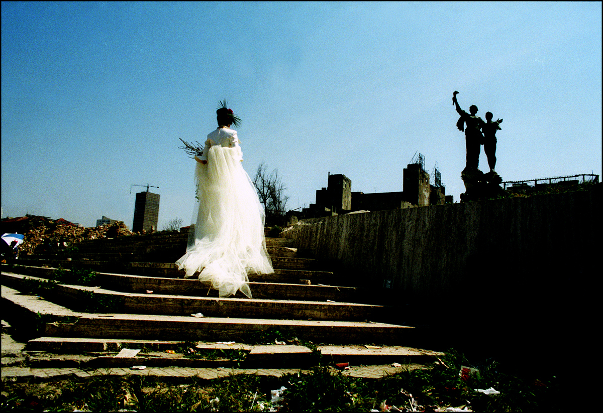 Lebanese Model climbs steps at the Martyr's square monument, Beirut 1993. : Lebanon 1981-2008 : BILL FOLEY 