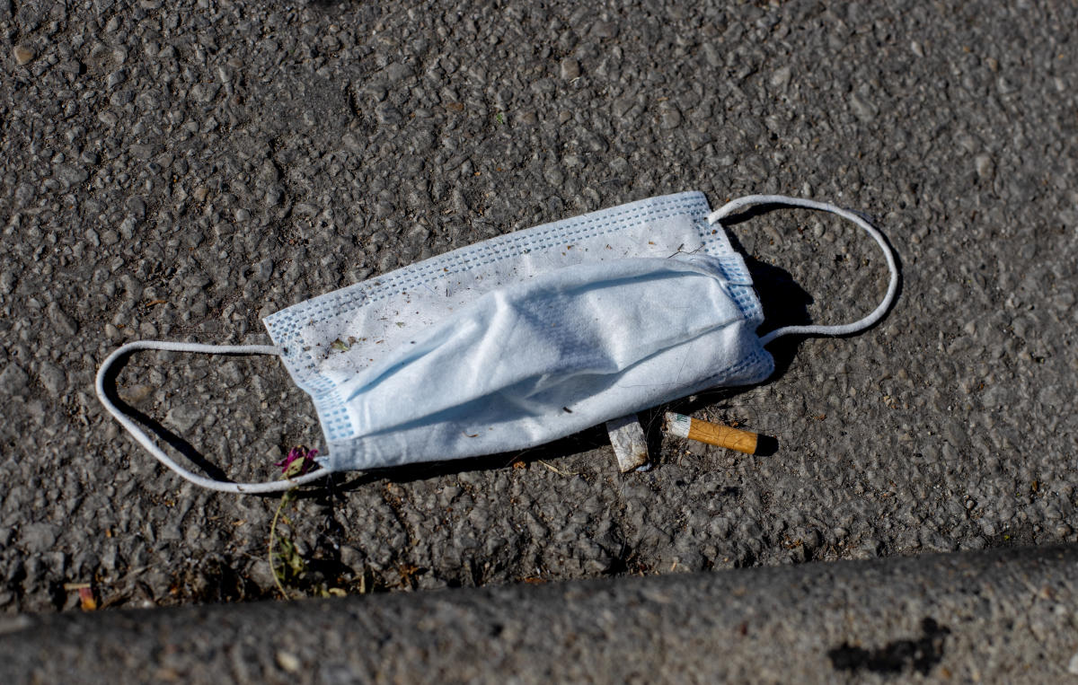 Pandemic trash in the street mask and cigarette butt in the street. : Observations in a Pandemic 2020-2021 : BILL FOLEY 