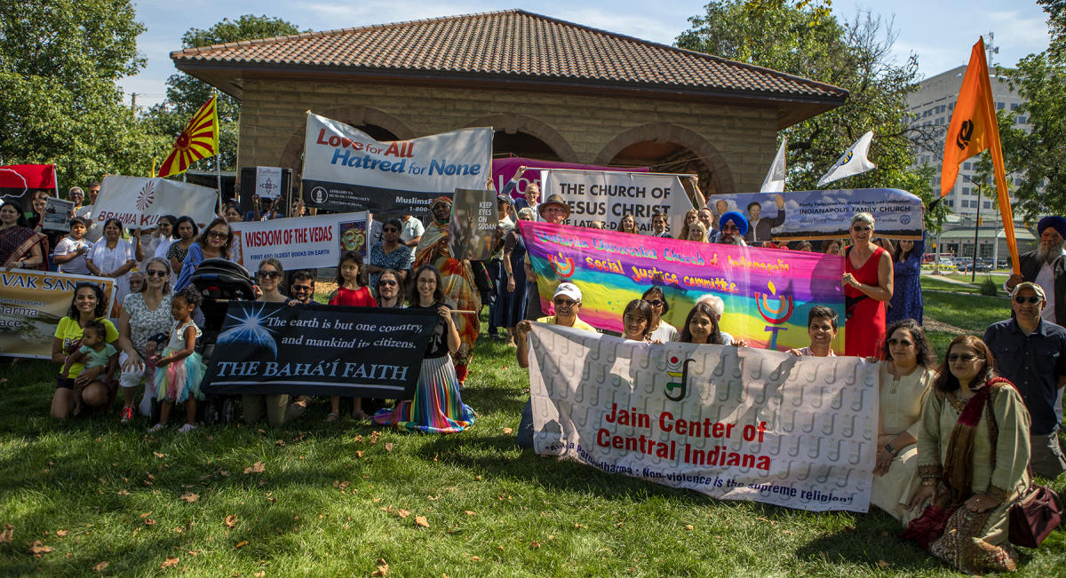 People carrying banners relax in front of the stage. : Festival of Faith, Back in Person! 2022. Military Park Downtown, Indianapolis, September 18, 2022! And Festival of Faith Pre-Pandemic 2019! : BILL FOLEY 